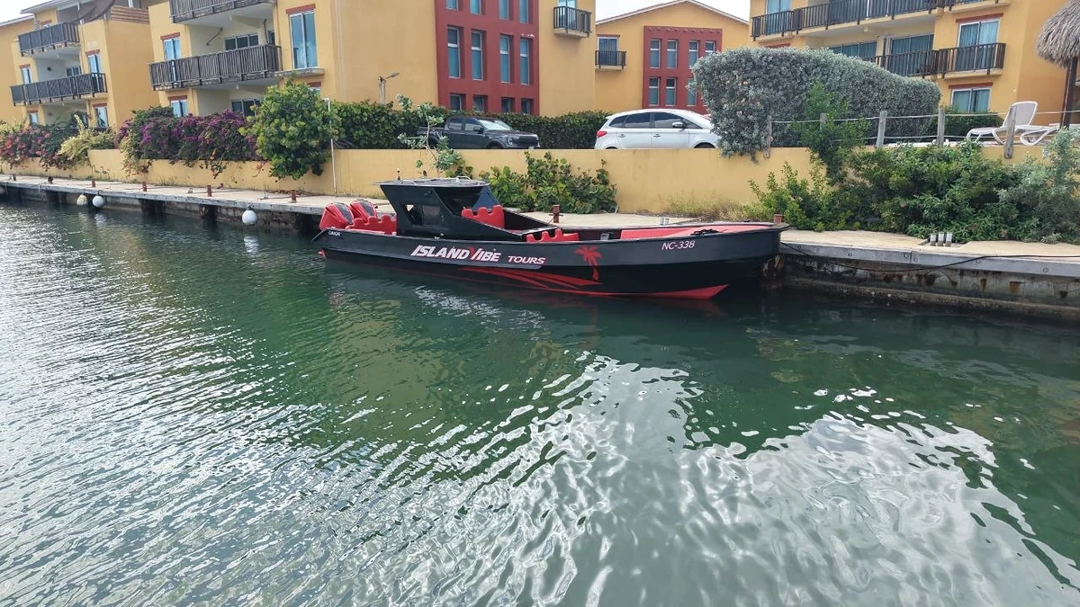 Red-and-black boat in full side profile